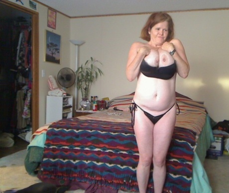 Busty granny toys her pussy after playing with nipple clamps