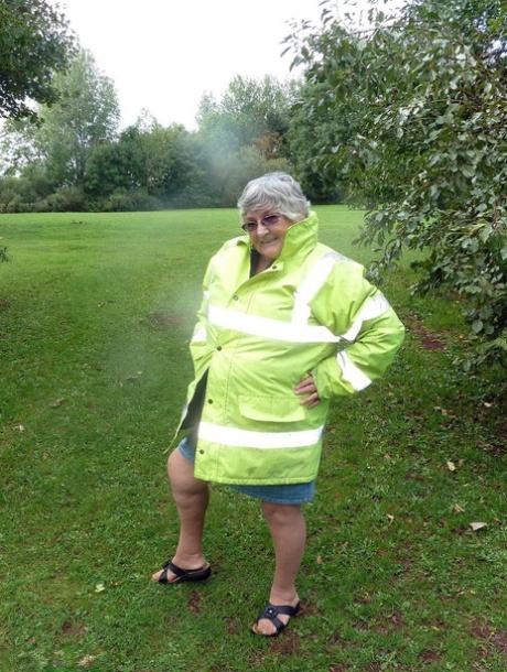 Fat British woman Grandma Libby exposes herself by a tree in a park
