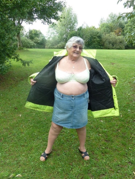 Fat British woman Grandma Libby exposes herself by a tree in a park