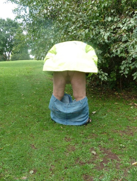 Fat British woman Grandma Libby exposes herself by a tree in a park