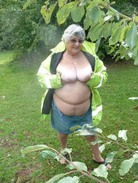 Fat British woman Grandma Libby exposes herself by a tree in a park