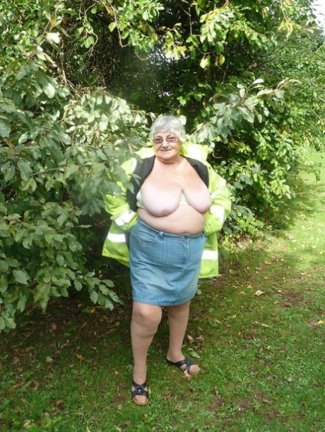 Fat British woman Grandma Libby exposes herself by a tree in a park