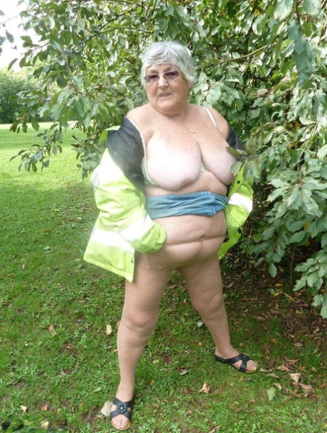 Fat British woman Grandma Libby exposes herself by a tree in a park