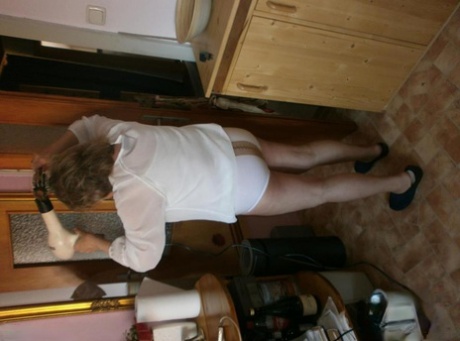 Hairy grandmother slides her upskirt panties aside to expose her vagina
