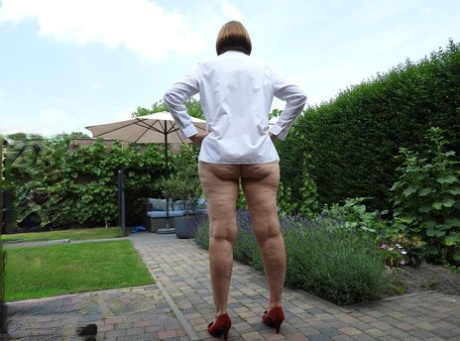 Old woman Kat Kitty gets naked on outdoor sofa while painting her toenails