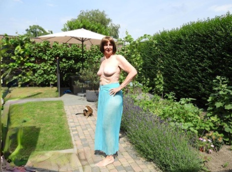 Old woman Kat Kitty gets naked on outdoor sofa while painting her toenails
