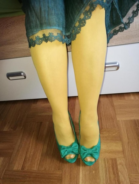 Old woman Caro releases her hairy vagina from yellow pantyhose on her bed