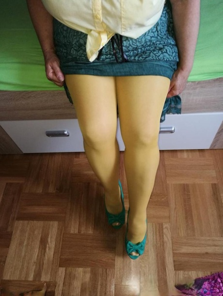 Old woman Caro releases her hairy vagina from yellow pantyhose on her bed