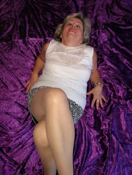Horny aged lady sniffs her panties before sliding hand down hose to masturbate