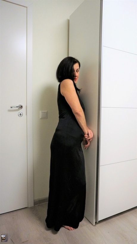 Dark-haired lady Diana Ananta hikes up her long dress to show her trimmed cunt