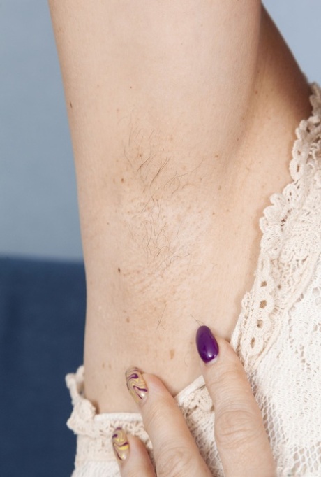 Older woman with short platinum blonde hair plays with her bush in the buff