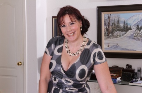Thick aged woman takes off her dress and black lingerie to pose naked on couch