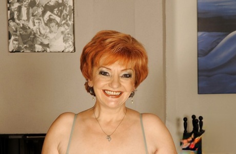 Busty granny on high heels shows her fatty body and her hairy cunt
