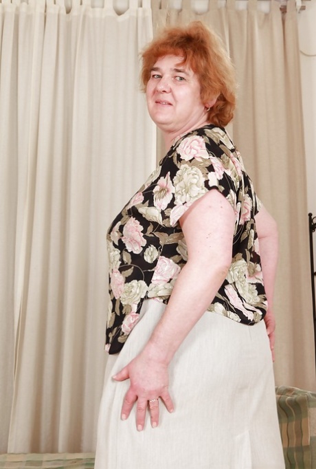 Redhead granny with massive flabby tits exposing her hairy cunt