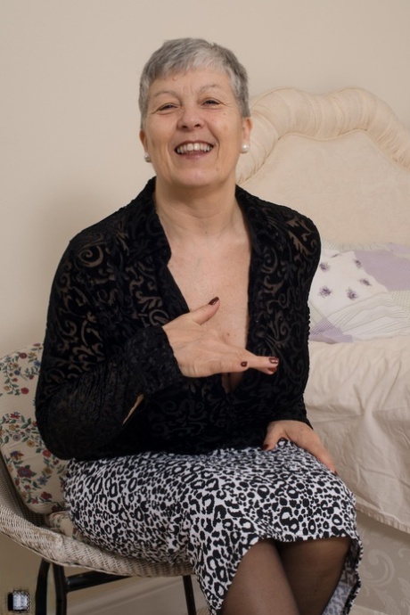 Charming granny Savana shows her big tits and poses in her sexy lingerie